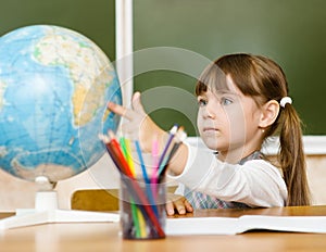 Portrait of lovely girl considers Globe