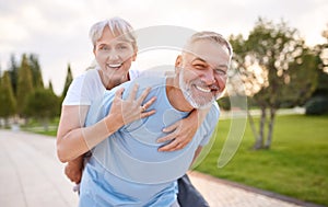 Portrait of lovely happy elderly couple on morning run outside in city park