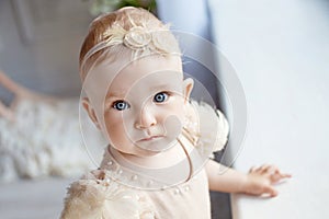 Portrait of the lovely little girl with blue eyes. Serious quiet look
