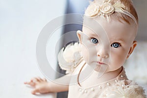 Portrait of the lovely little girl with blue eyes. Serious quiet look. Copy space
