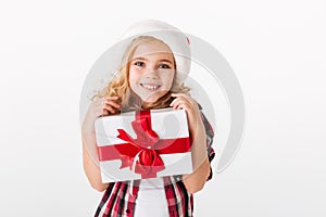 Portrait of a lovely little girl holding gift box