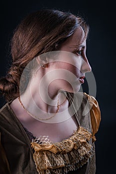 Portrait of lovely medieval girl in a dark tower