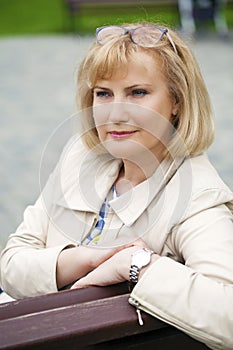 portrait of lovely middle aged woman in the summer park