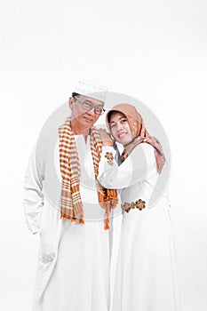 Portrait lovely senior asian muslim married couple. embracing each other and going for ramadan eid mubarak celebration concept