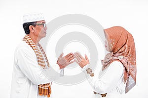 Portrait lovely senior asian muslim married couple. embracing each other and going for ramadan eid mubarak celebration concept