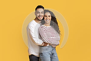 Portrait Of Loving Arab Man And Woman Embracing And Smiling At Camera