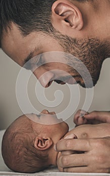 Portrait of loving father with baby at home. Sepia Toned