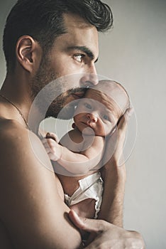 Portrait of loving father with baby at home. Sepia Toned