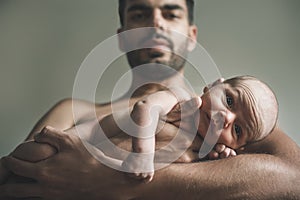 Portrait of loving father with baby at home. Sepia Toned