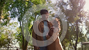 Portrait loving father hugging smiling daughter looking each other green park.