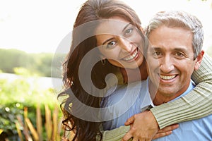 Portrait Of Loving Hispanic Couple In Countryside