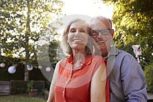 Portrait Of Loving Mature Couple In Back Yard Garden