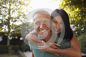 Portrait Of Loving Mature Couple In Back Yard Garden