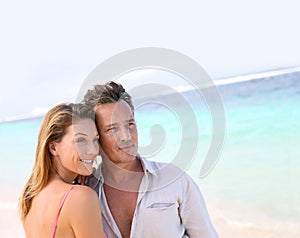 Portrait of loving middle-aged couple enjoying on the beach