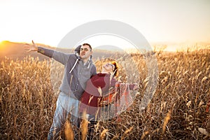 Portrait of loving middle-aged couple in warm clothes hugging in the autumn park at sunset in selective focus