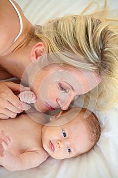 Portrait of a loving mother and child. High angle shot of a mother and her newborn child lying in bed.