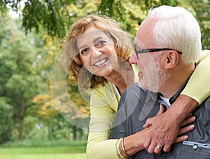 Portrait of a loving older couple smiling outdoors
