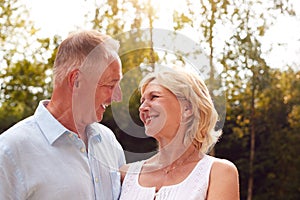 Portrait Of Loving Senior Couple In Garden At Home Together