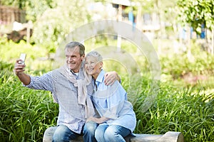 Senior Couple Taking Selfie Outdoors