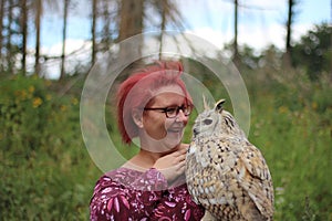 Portrait of a loving woman holding an owl outdoors in Menden Sauerland photo