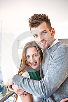 Portrait of loving young man hugging woman at cafe