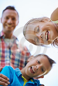 Portrait, low angle and family with summer happiness and bonding together with weekend break. Face, parents and mother