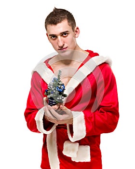 Portrait of macho man in santa costume small Christmas tree over white