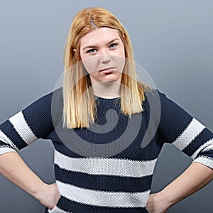 Portrait of mad woman against gray background