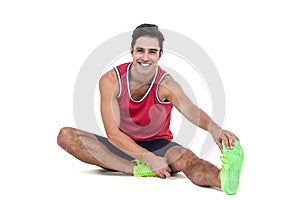 Portrait of male athlete stretching his hamstring