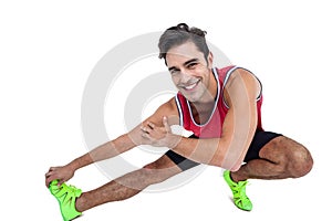 Portrait of male athlete stretching his hamstring