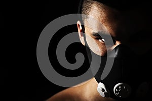 Portrait of male athlete wearing training mask.