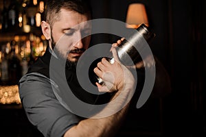 Portrait of male bartender with shaker in his hands