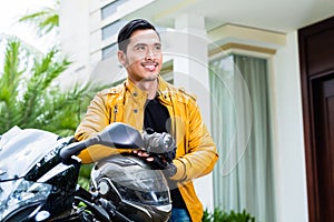 Portrait of male biker with bike and helemt