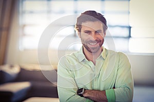 Portrait of male business executive smiling with arms crossed