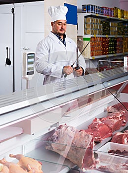 Portrait of male butcher in kosher section at supermarket