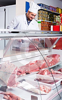 Portrait of male butcher in kosher section at supermarket