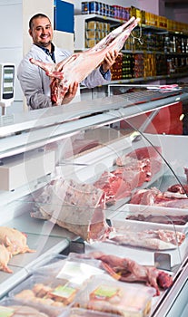 Portrait of male butcher in kosher section at supermarket