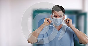 Portrait of male Caucasian health worker wearing face mask in hospital