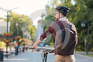 Portrait of a male commuter wearing bike helmet in a town.