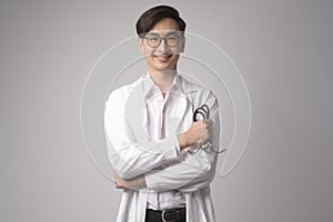 Portrait of male confident doctor over white background studio, healthcare and Medical technology concept