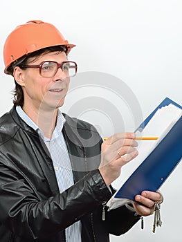 Portrait of male construction worker construction superintendent in glasses protective helmet with a folder of documents and