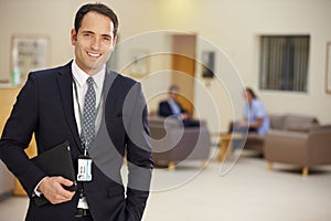 Portrait Of Male Consultant In Hospital Reception