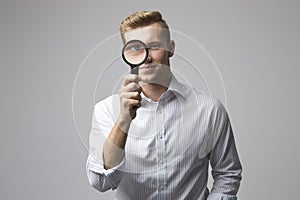 Portrait Of Male Criminologist With Magnifying Glass photo