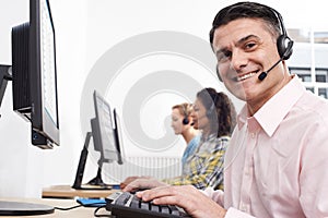 Portrait Of Male Customer Services Agent In Call Centre