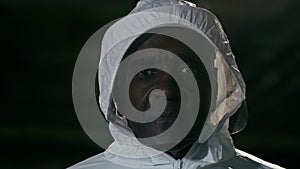 Portrait male doctor medical worker in special protective white chemical uniform fights with epidemic looking at camera