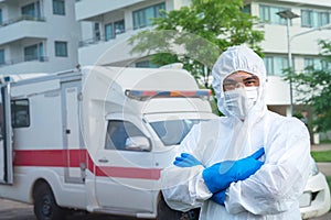 Portrait of a male doctor nurse staff wear PPE in front of the ambulance with protective suit, mask gloves at ambulance car