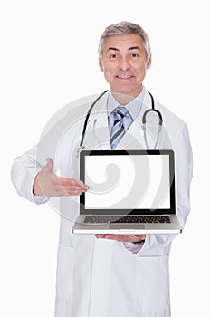 Portrait Of Male Doctor Showing Laptop