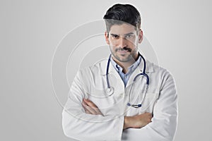 Portrait of male doctor standing at isolated white background