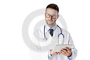 Portrait of male doctor standing at isolated white background with digital tablet