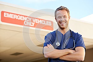 Portrait Of Male Doctor Standing Outside Hospital